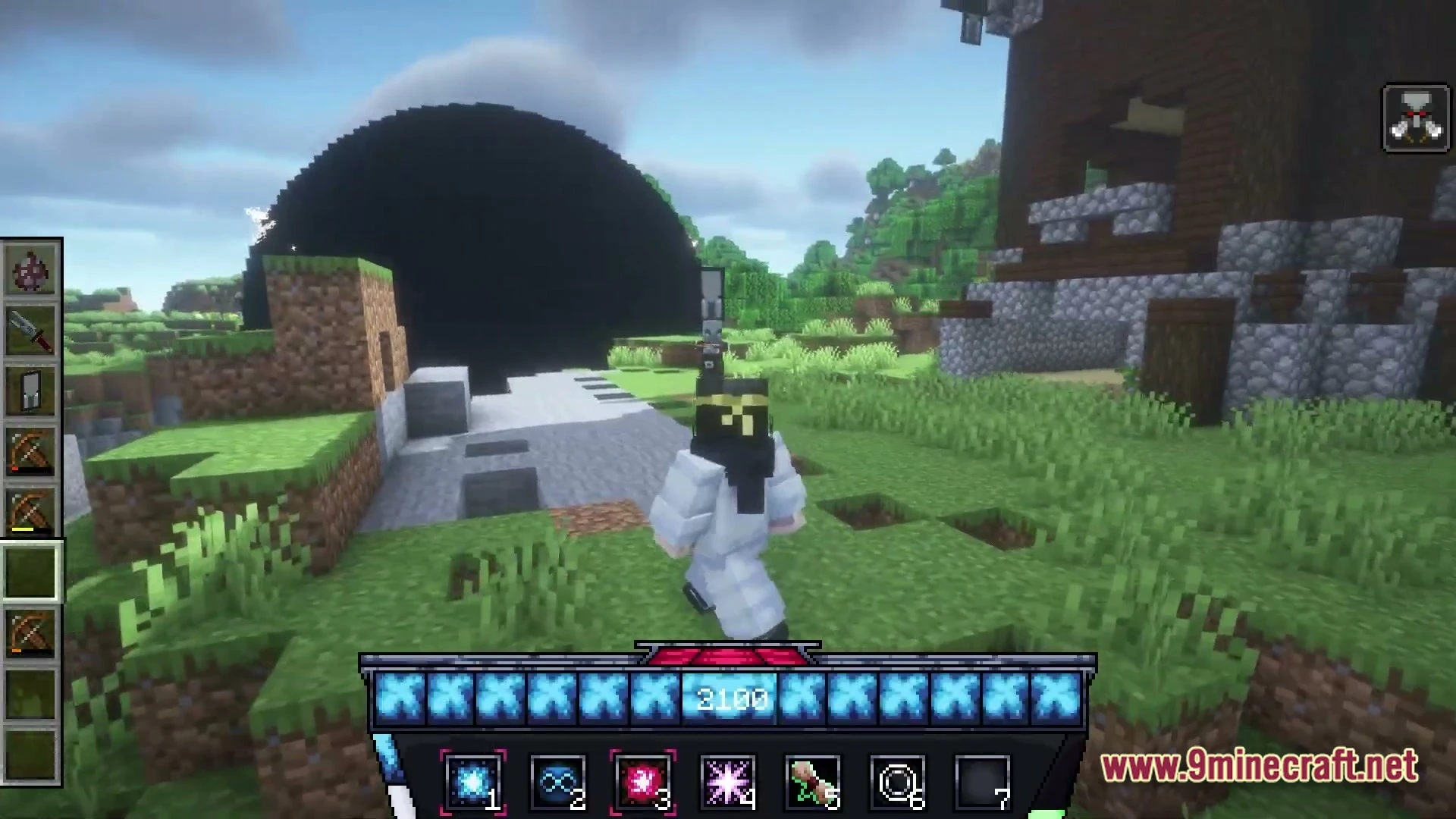 A player character stands near a large black sphere and a wooden structure in a grassy biome