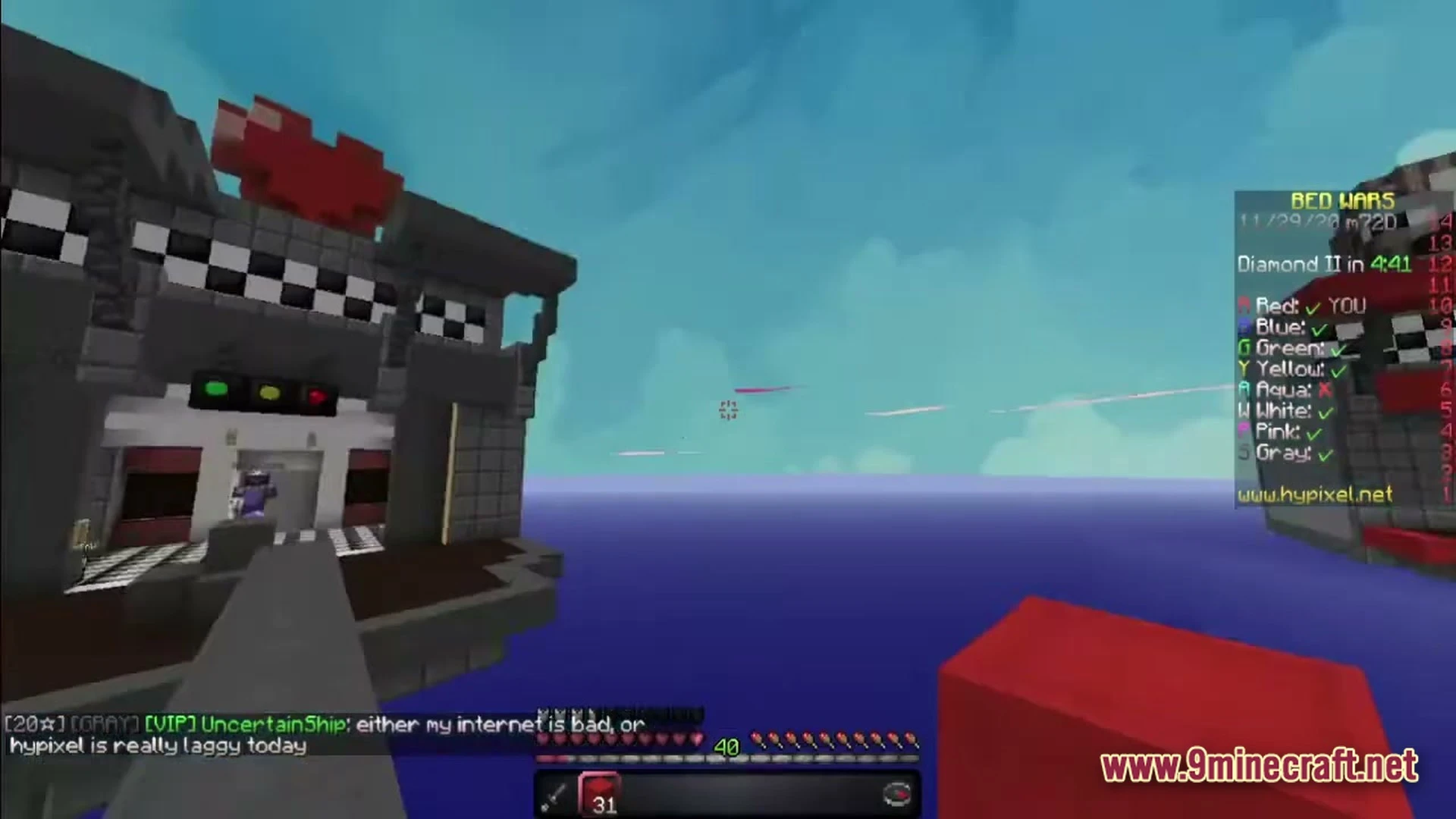 A first-person view of a bed wars match on the hypixel server featuring floating island structures