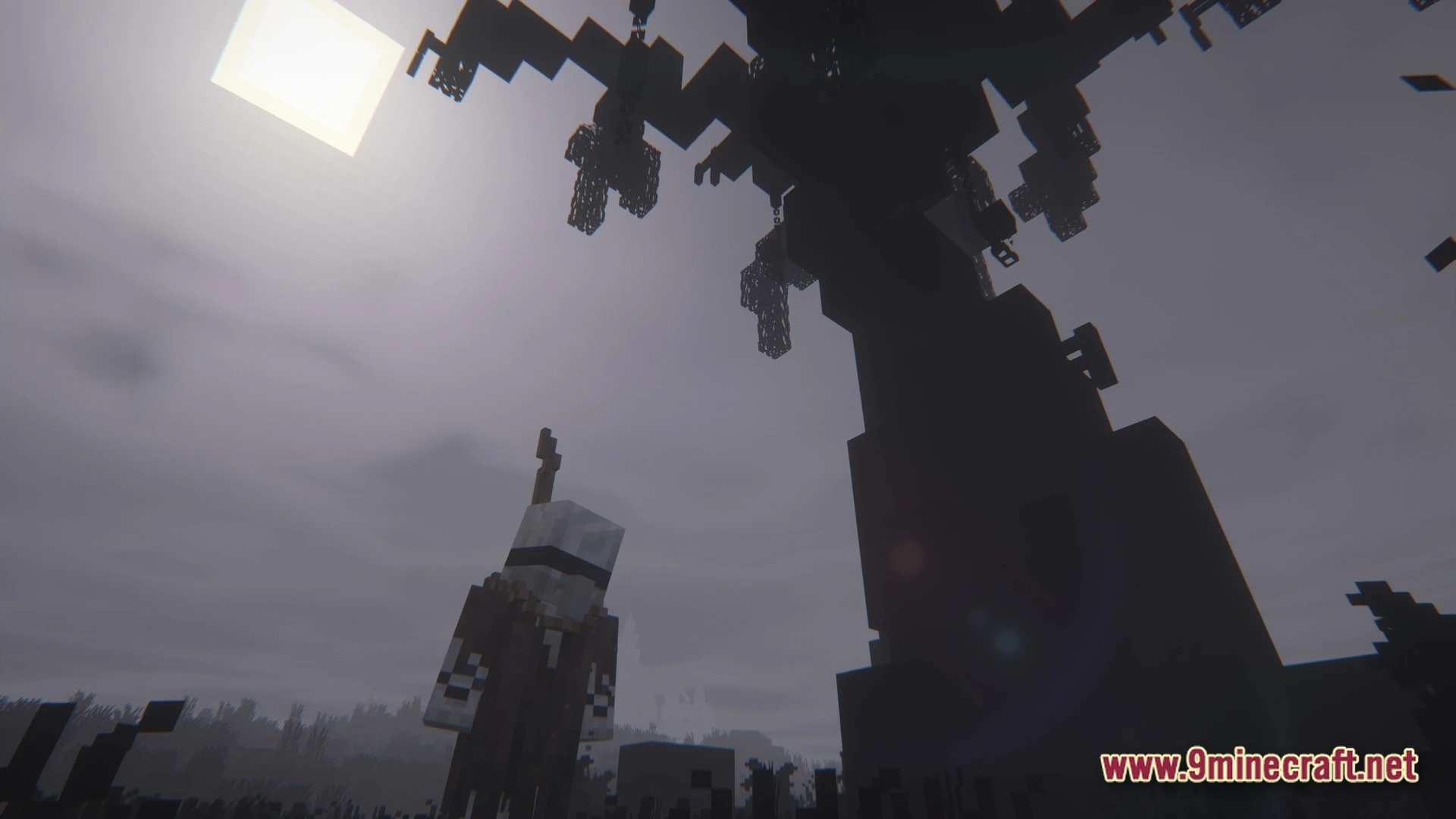 Grimsoul Unleashed Modpack (1.20.1) – Ai Survival Horror Adventure 11 A player character stands beneath a large dark tree with hanging cages under a grey sky