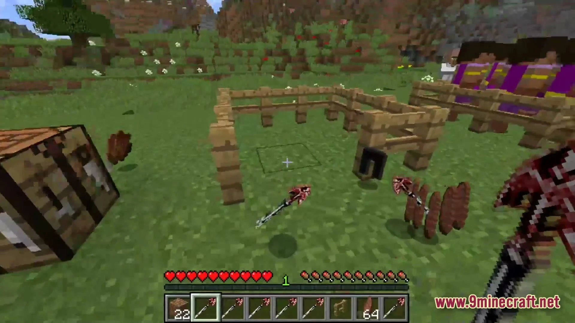 A player holds a red weapon near wooden fences, dropped items, and a crafting table