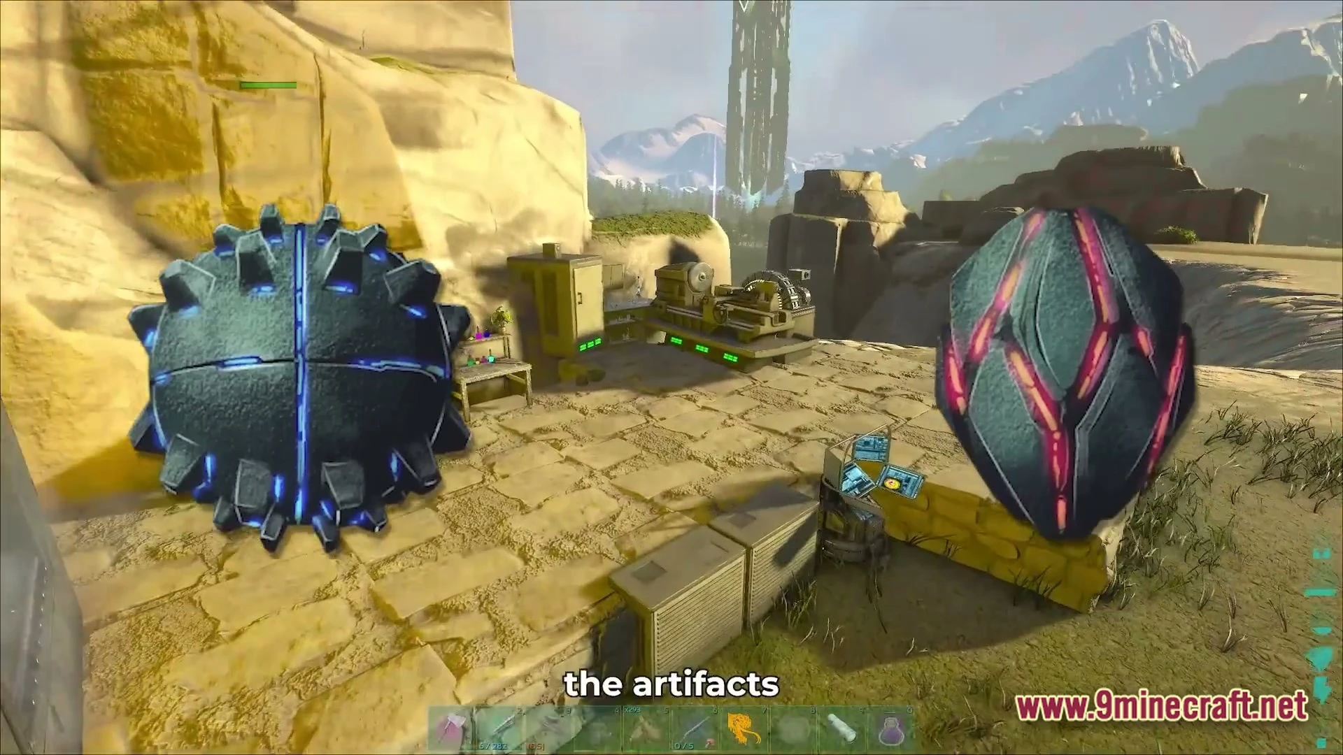 Two large glowing artifacts sit near industrial machinery on a stone platform in a mountainous landscape