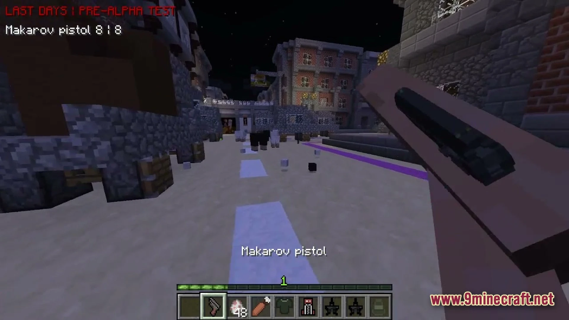 A player holds a makarov pistol while exploring a city street at night in minecraft