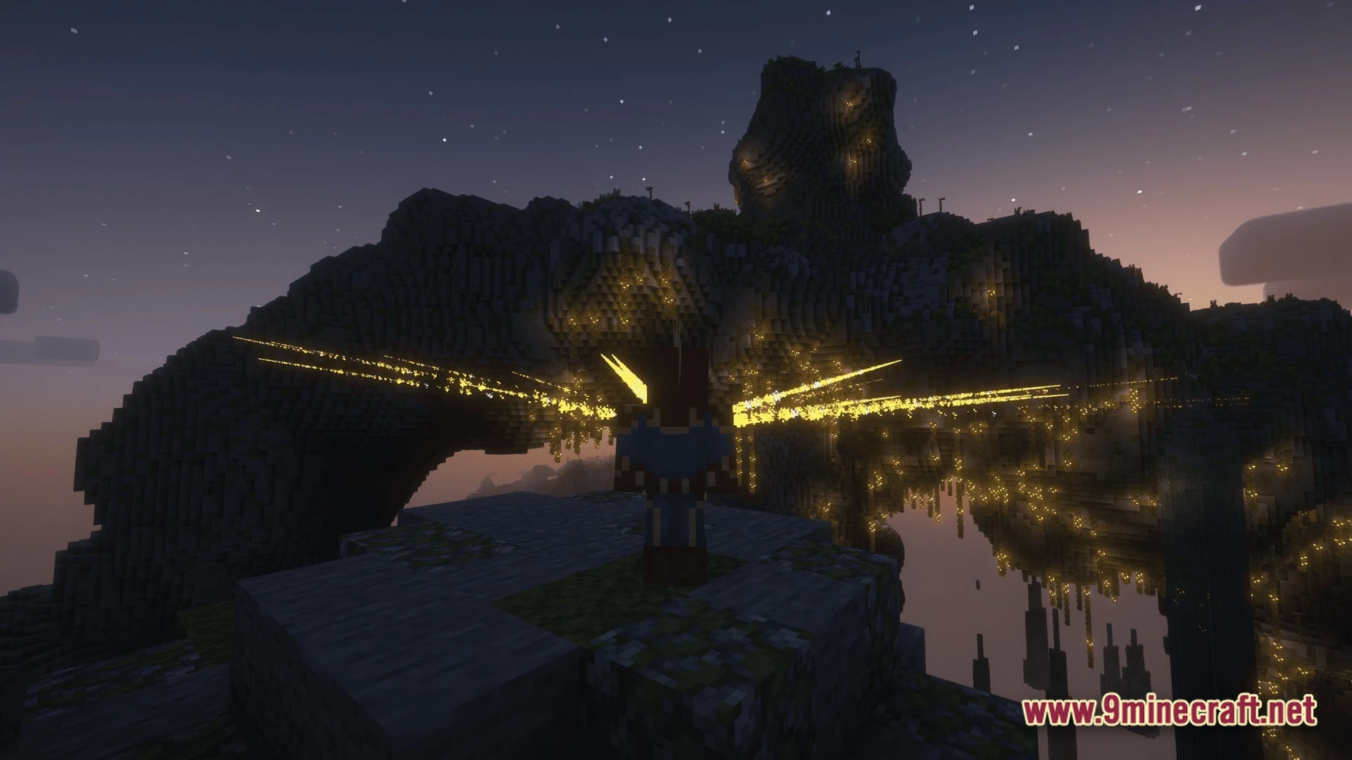 A player character with glowing wings stands before a large mountain archway at twilight