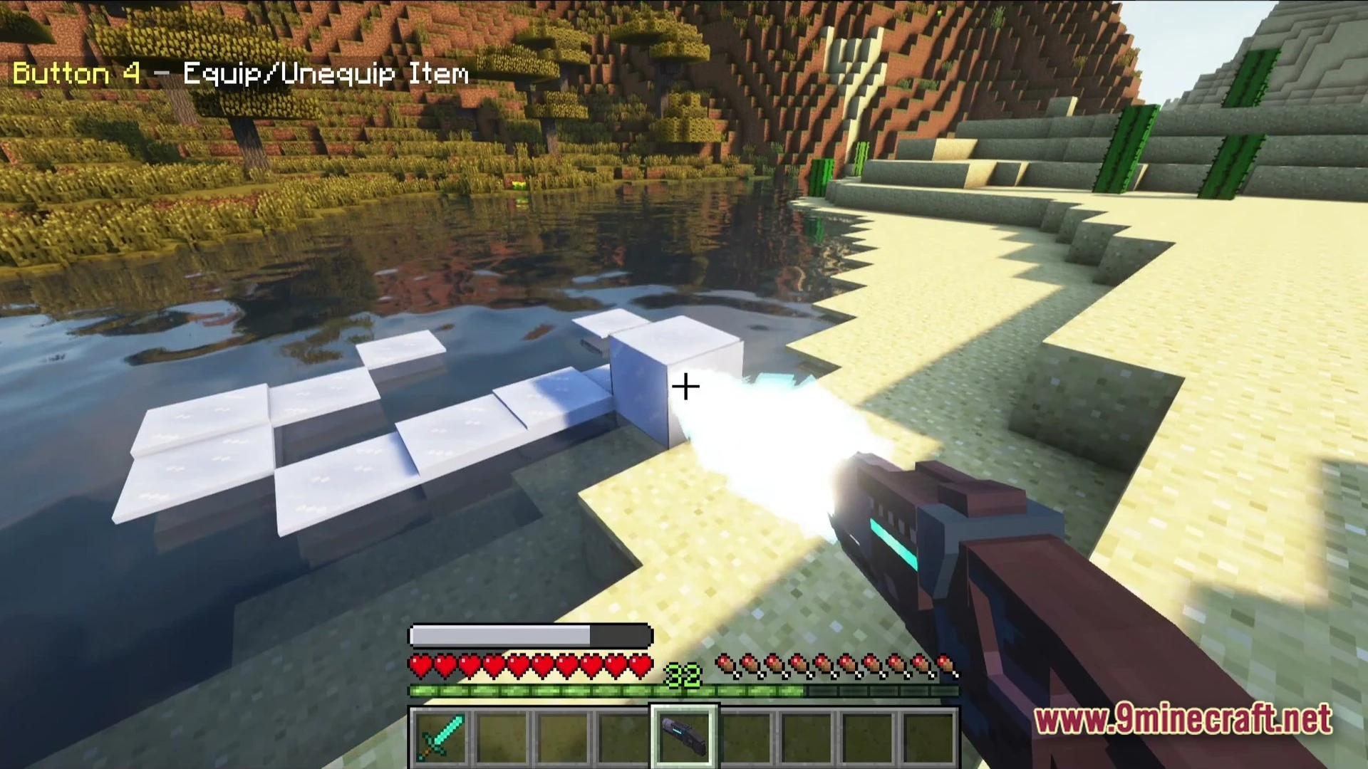 A player uses a futuristic freeze ray to create ice platforms on a desert river