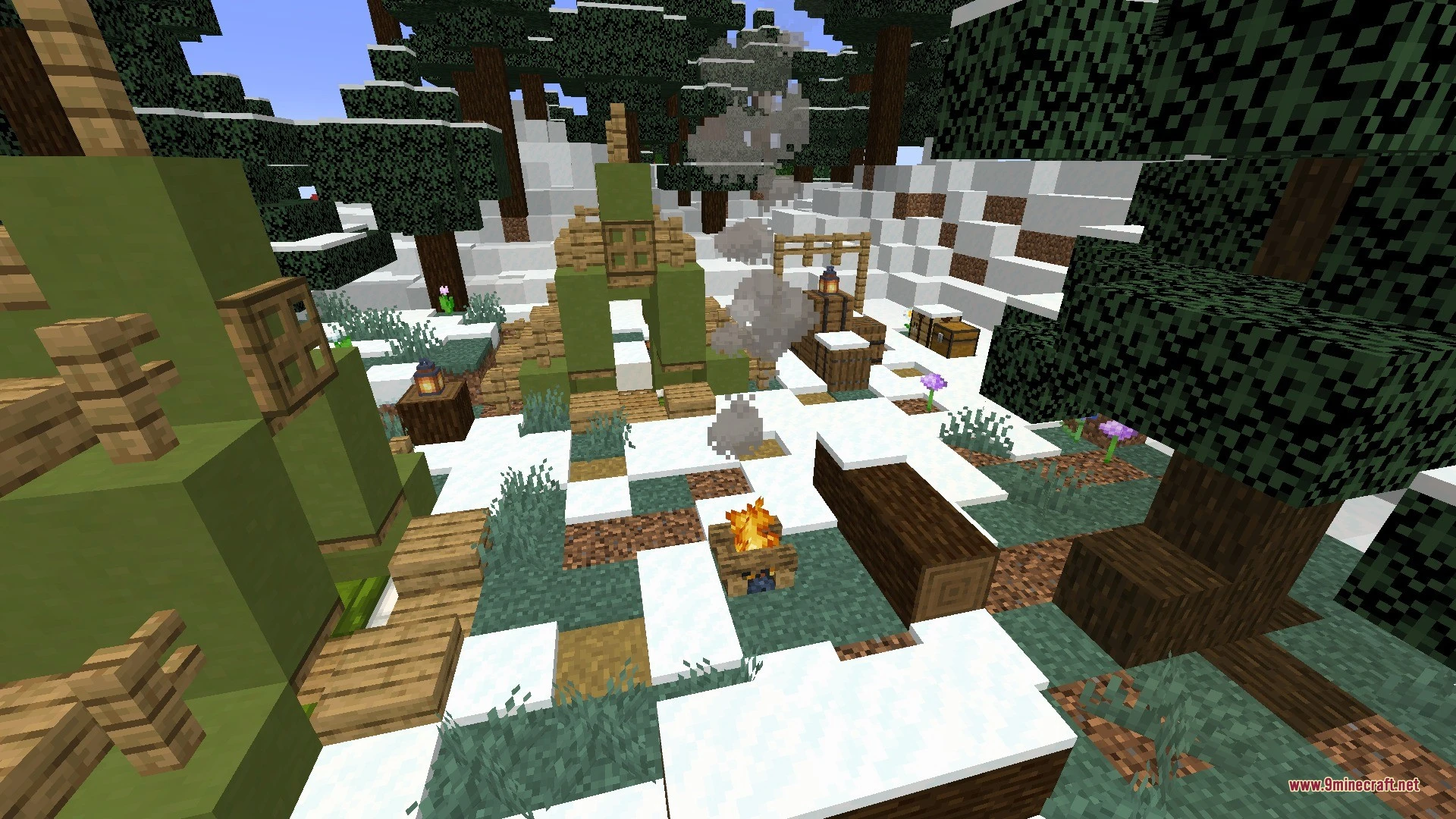 Green tents and a campfire set up in a snowy forest clearing