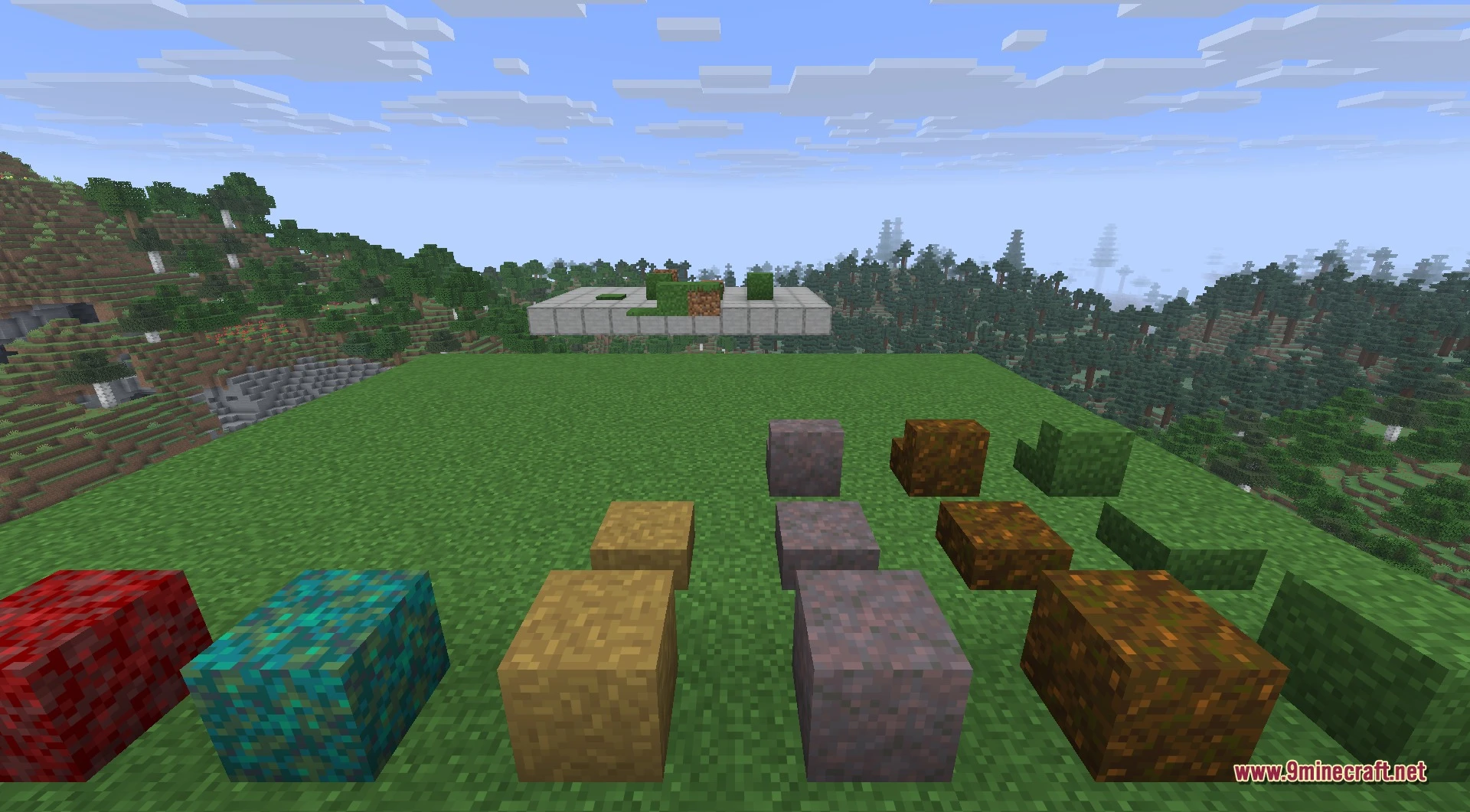 Various colorful grass blocks slabs and stairs displayed on a flat green field