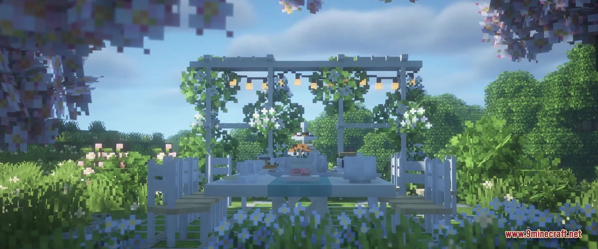 Outdoor dining area with white furniture and tea set under a decorated pergola