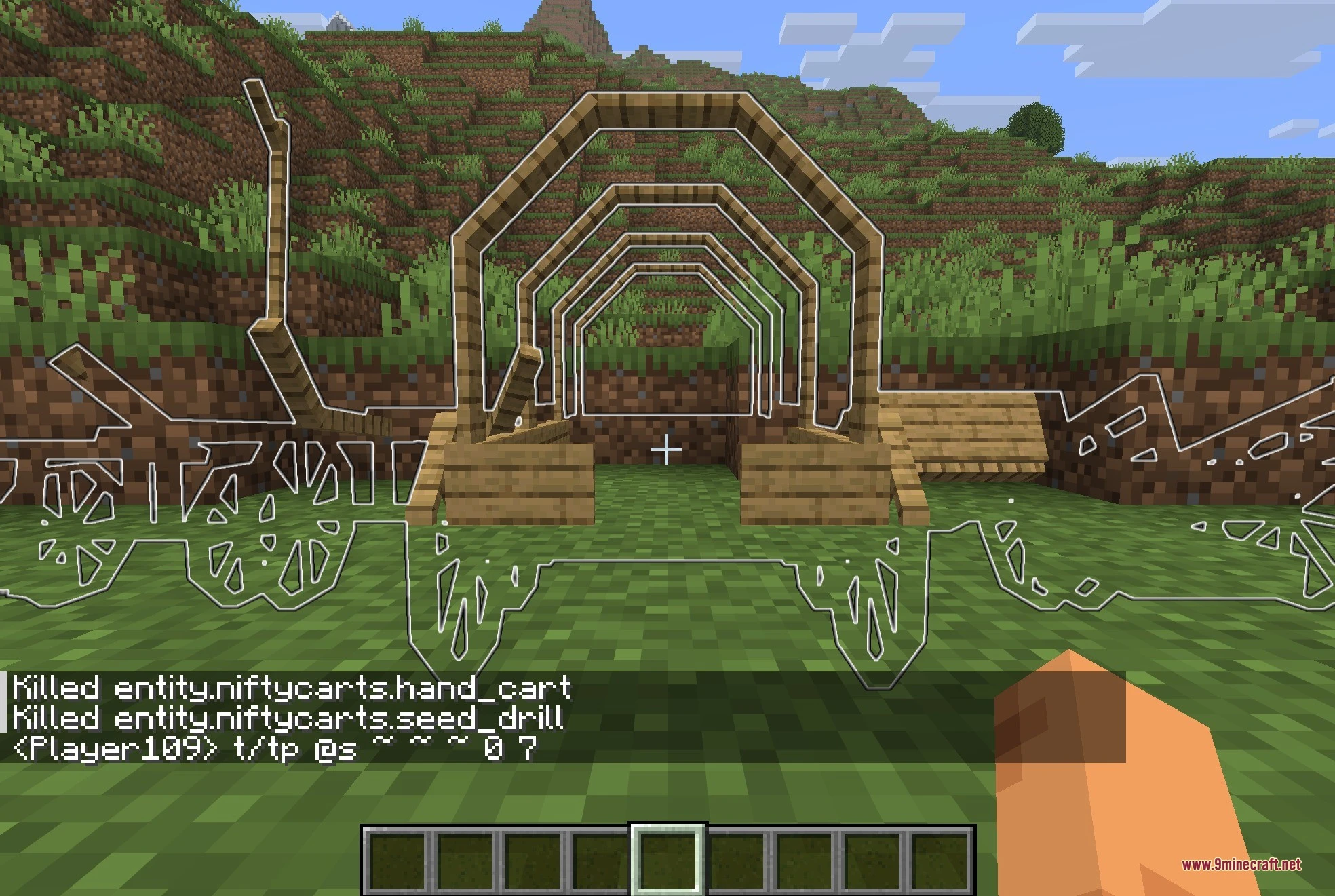 White outlines of different wooden carts and wagons placed in a field
